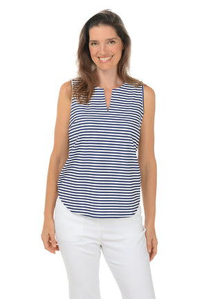 Woman wearing a sleeveless striped shirt and white pants on a white background.
