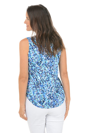 Woman wearing a blue floral sleeveless top on a white background. Back shot.