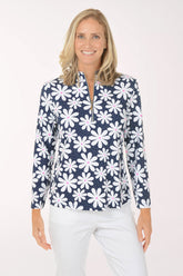 Woman wearing a navy floral patterned shirt on a white background