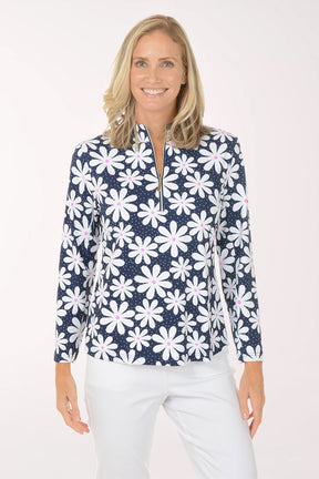 Woman wearing a navy floral patterned shirt on a white background