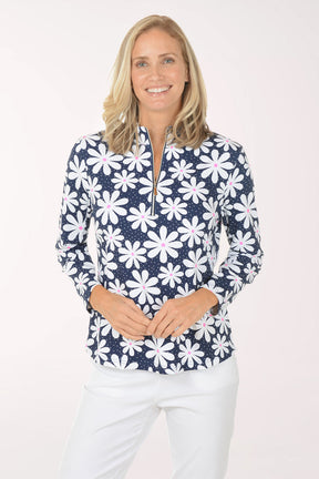 Woman wearing a navy floral patterned shirt on a white background