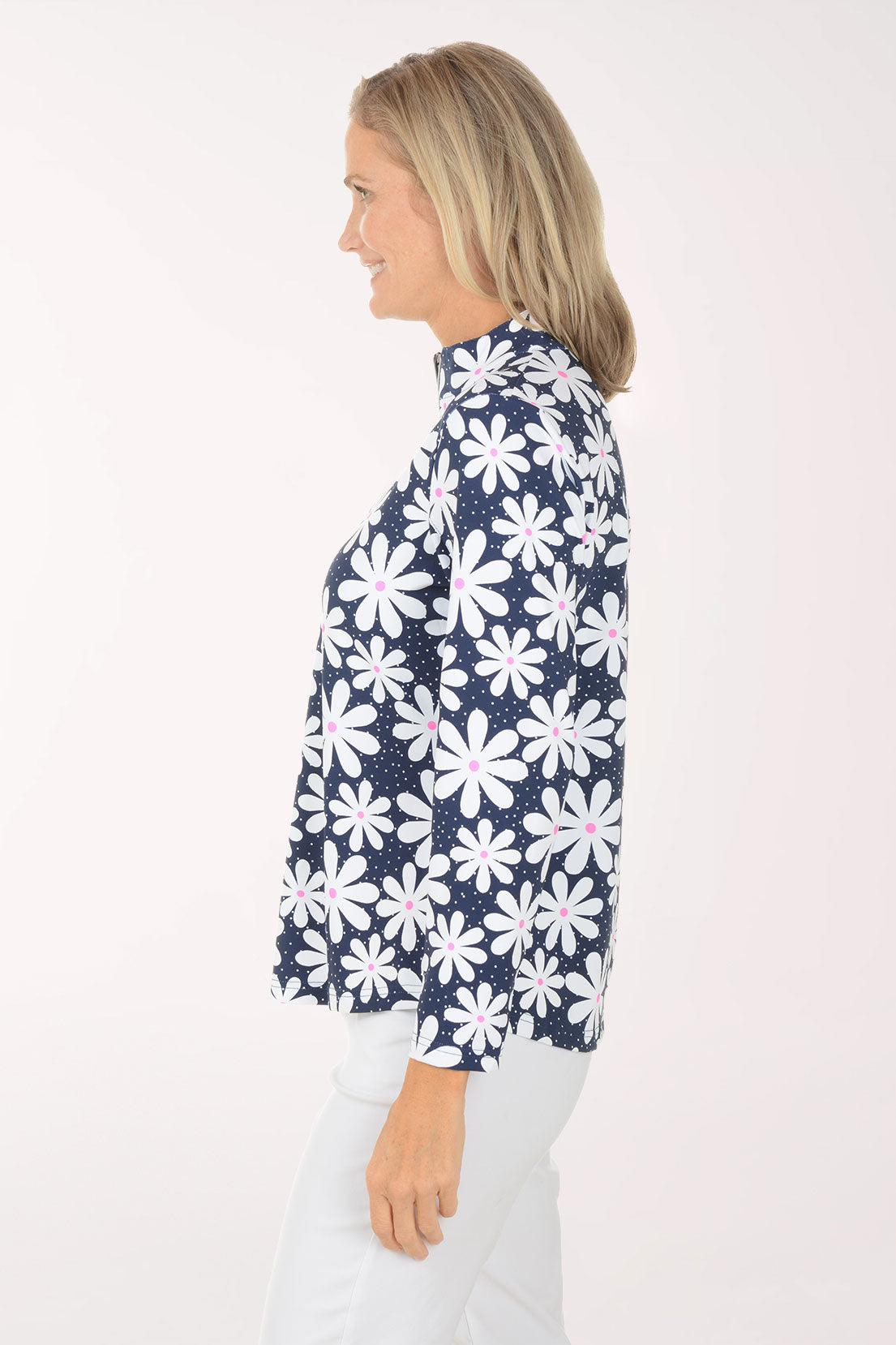 Woman wearing a navy floral patterned shirt on a white background