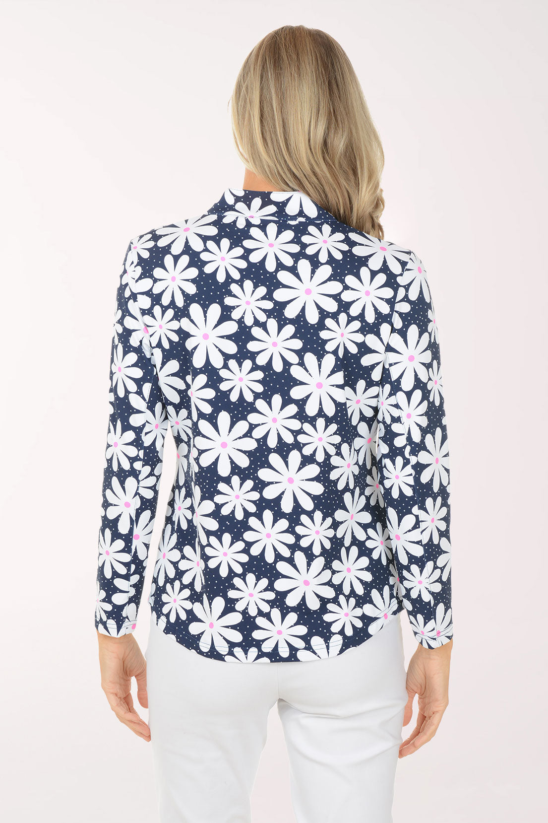 Woman wearing a navy floral patterned shirt on a white background