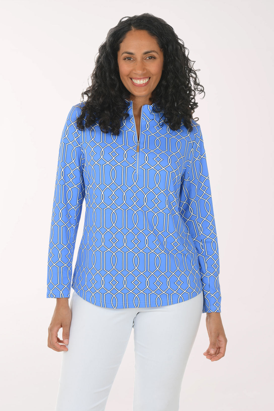 Woman wearing a blue patterned long-sleeve top on a white background