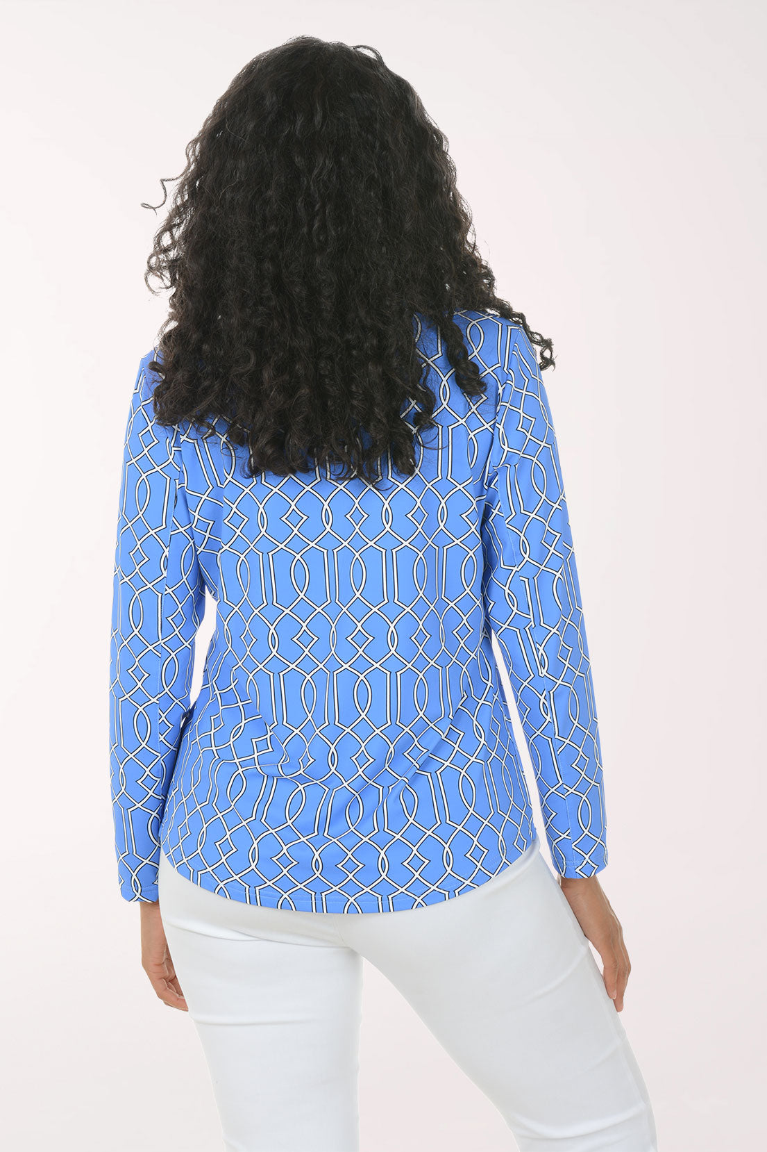 Woman wearing a blue geometric patterned blouse on a white background