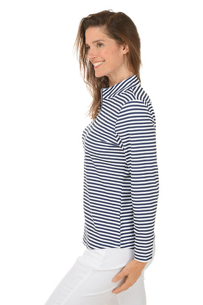 Woman wearing a navy and white striped shirt with a white background. Side shot.