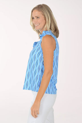 Woman wearing a blue patterned sleeveless top on a white background