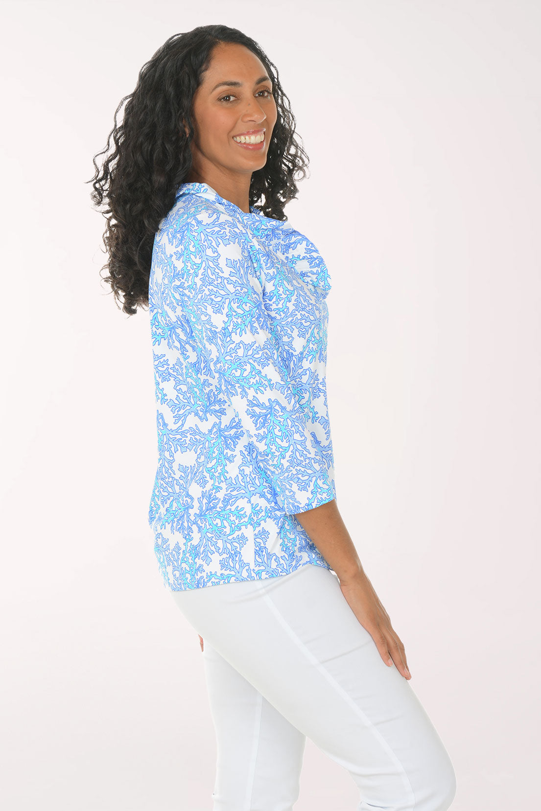 Woman wearing a blue floral blouse with a white background