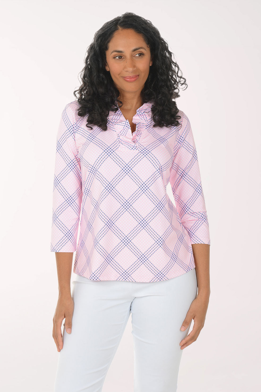Woman wearing a pink and white checkered blouse with a white background