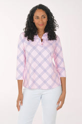 Woman wearing a pink and white checkered blouse with a white background