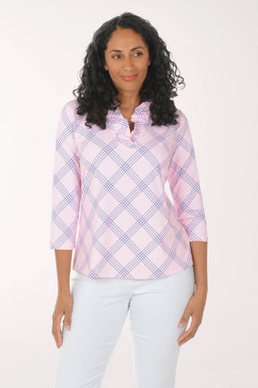 Woman wearing a pink and white checkered blouse with a white background
