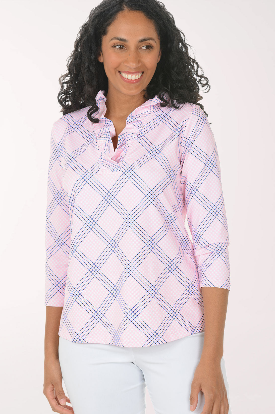 Woman wearing a pink and white checkered blouse with a white background