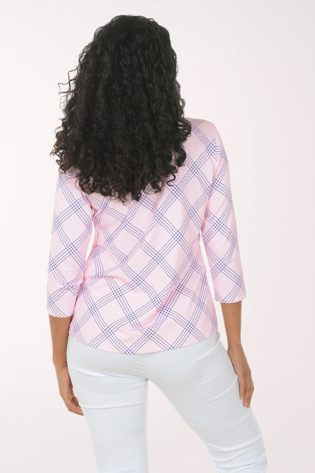 Woman wearing a pink and white checkered blouse with a white background
