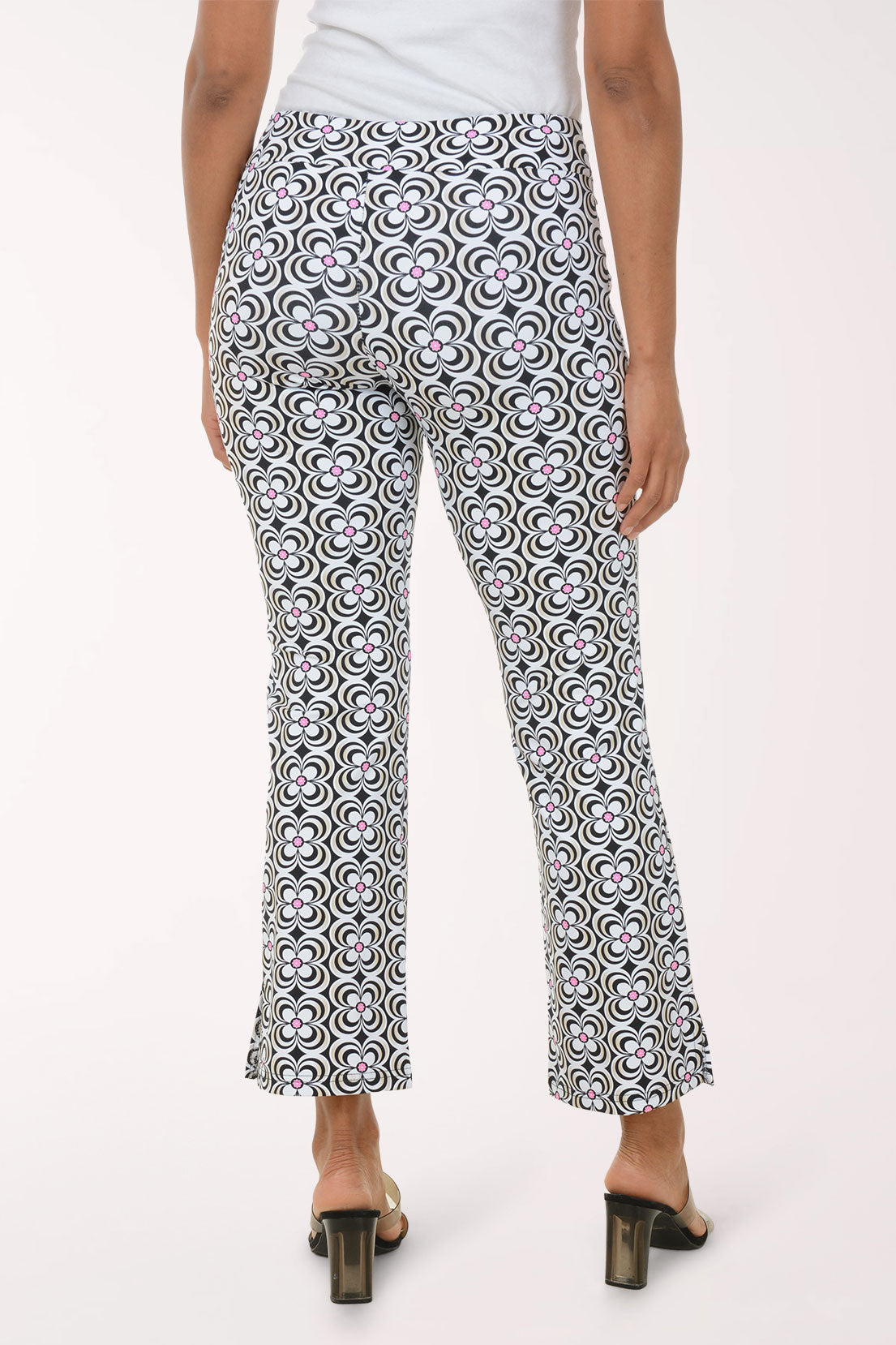 Person wearing a patterned black and white pants on a white background