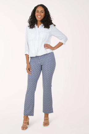 Woman wearing a white blouse and patterned pants on a white background