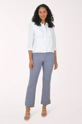 Woman wearing a white blouse and patterned pants on a white background