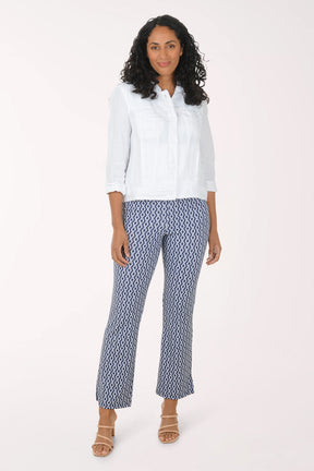 Woman wearing a white blouse and patterned pants on a white background
