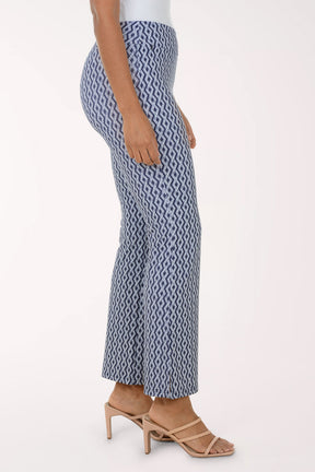 Woman wearing a white blouse and patterned pants on a white background