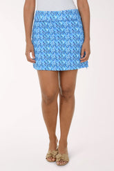 Person wearing a blue patterned skirt on a white background