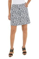 Person wearing a leopard print skirt on a white background.