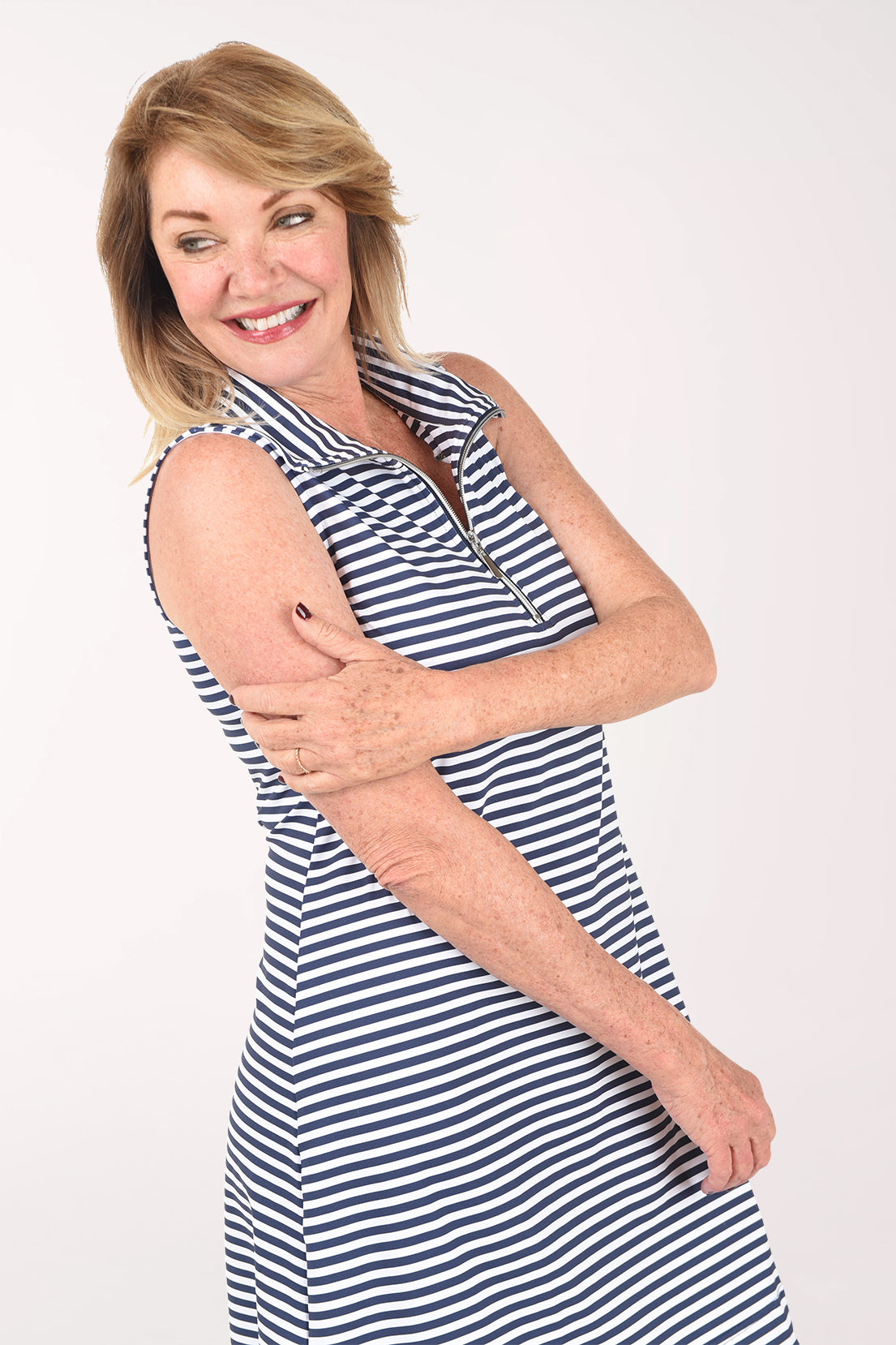 Woman wearing a blue and white striped dress on a white background