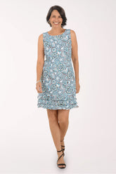 Woman wearing a blue floral dress on a white background