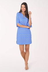 Woman wearing a blue patterned dress on a white background
