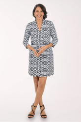 Woman wearing a black and white patterned dress on a white background