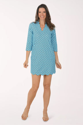 Woman wearing a blue patterned dress on a white background