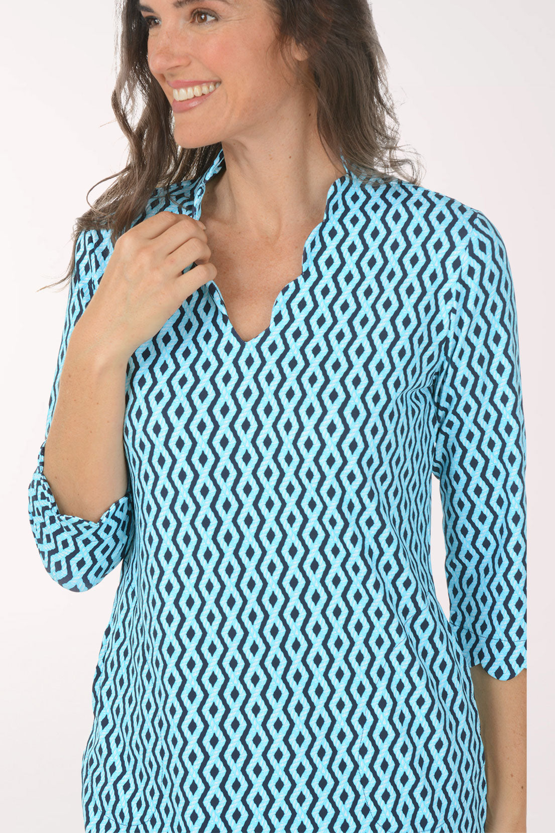 Woman wearing a blue patterned dress on a white background