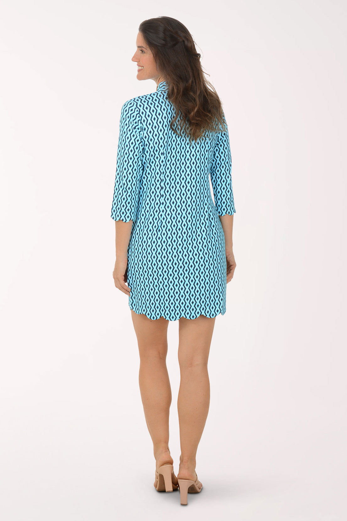 Woman wearing a blue patterned dress on a white background