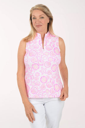 Woman wearing a pink sleeveless top with shell pattern on a white background