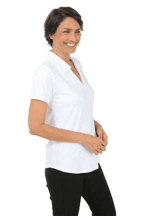 Woman wearing a white short-sleeve blouse and black pants on a white background. Side shot.