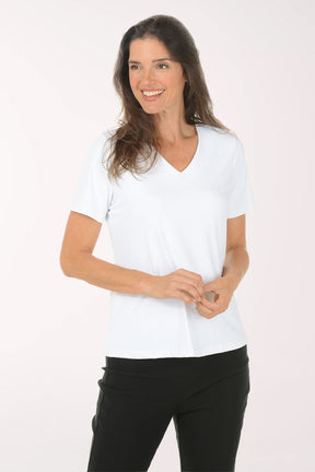 Woman wearing a white V-neck shirt and black pants on a white background