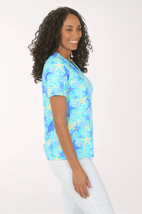 Woman wearing a blue starfish patterned shirt on a white background