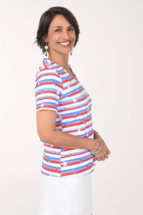 Woman wearing a red, white, and blue striped shirt with star pattern on a white background