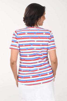 Woman wearing a red, white, and blue striped shirt with star pattern on a plain background