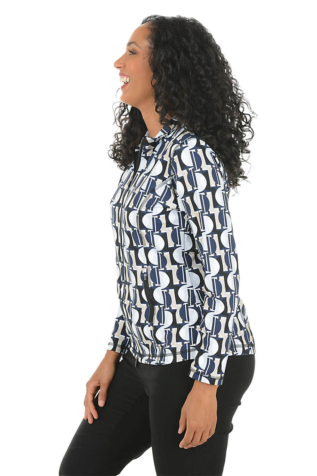A woman wearing a patterned athletic jacket against a white background. Side shot.