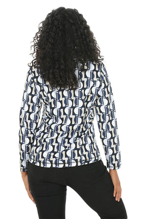 A woman wearing a patterned athletic jacket against a white background. Back shot.