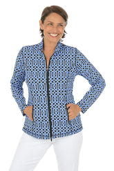 Woman wearing a blue patterned jacket on a white background.