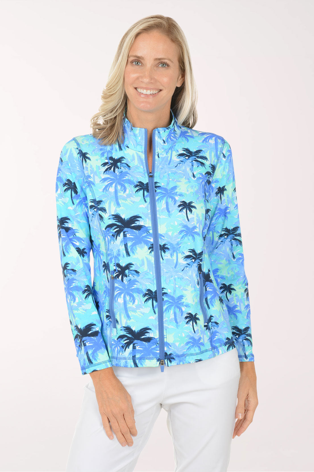 Woman wearing a blue palm tree patterned jacket on a white background