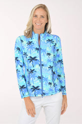 Woman wearing a blue palm tree patterned jacket on a white background