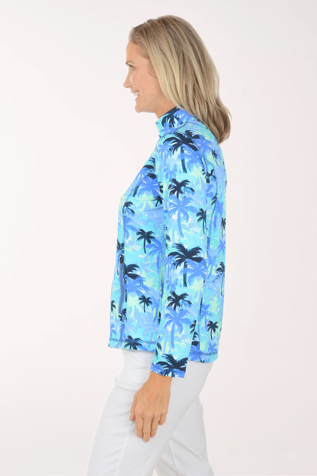 Woman wearing a blue palm tree patterned jacket on a white background