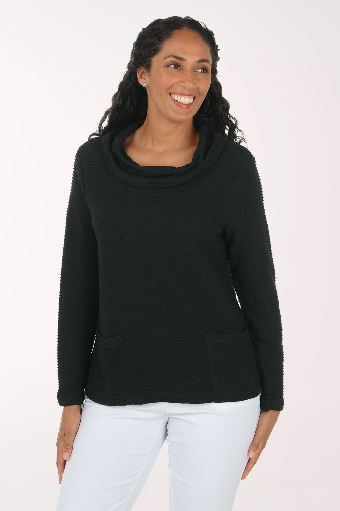 Woman wearing a solid black cowl neck long sleeve top