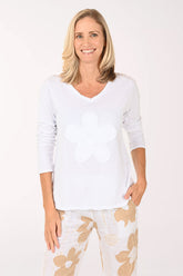 Woman wearing a long sleeve white top