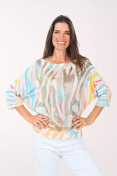 Woman wearing a colorful blouse with a white background