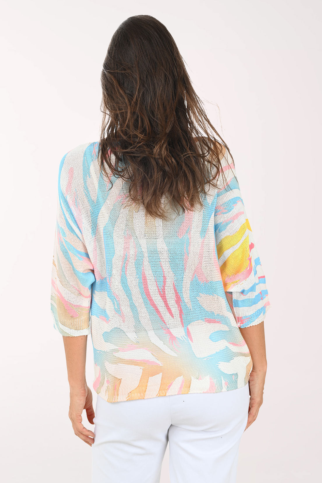 Woman wearing a colorful blouse with a white background