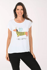 Woman wearing a white t-shirt with a colorful dog graphic and 'Bee Happy' text on a plain background