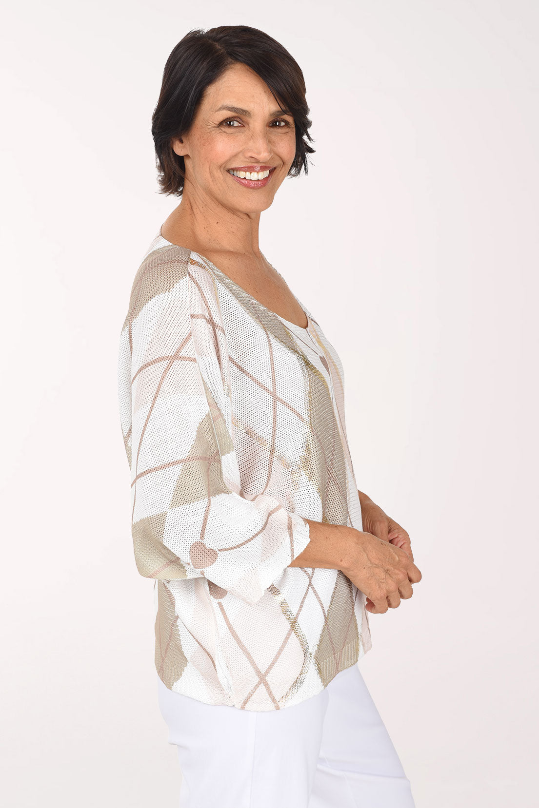Side view showing the wide crew neckline, relaxed sleeves and white and beige argyle pattern