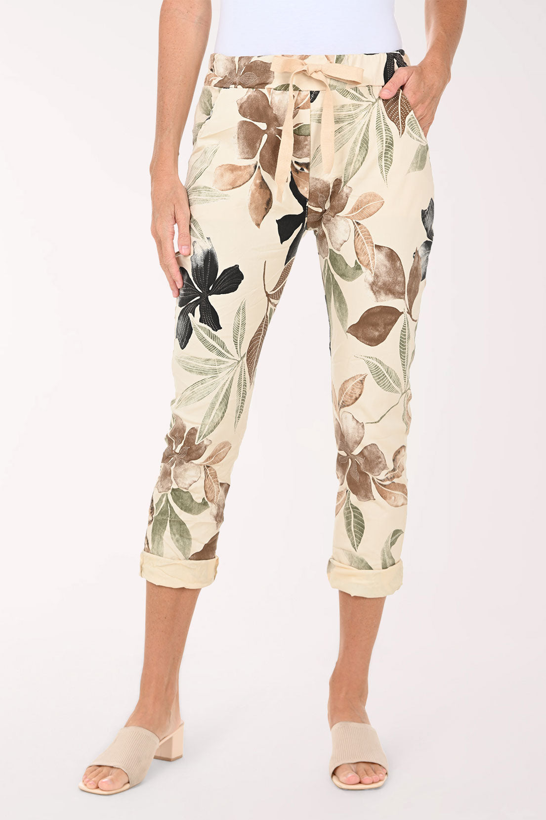 Capri pants with floral pattern worn by a person on a white background